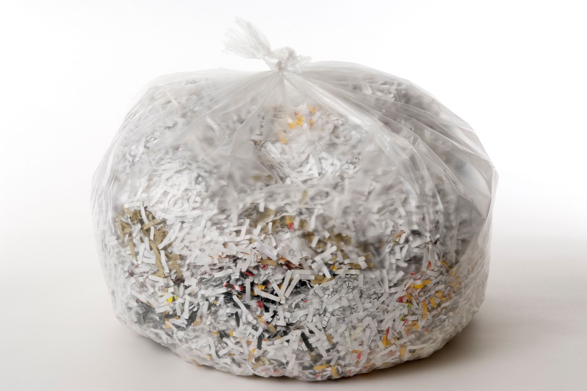 A bag of shredded paper is sitting on a white surface.