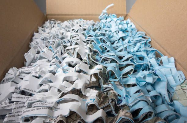 A box filled with shredded paper is sitting on a table.