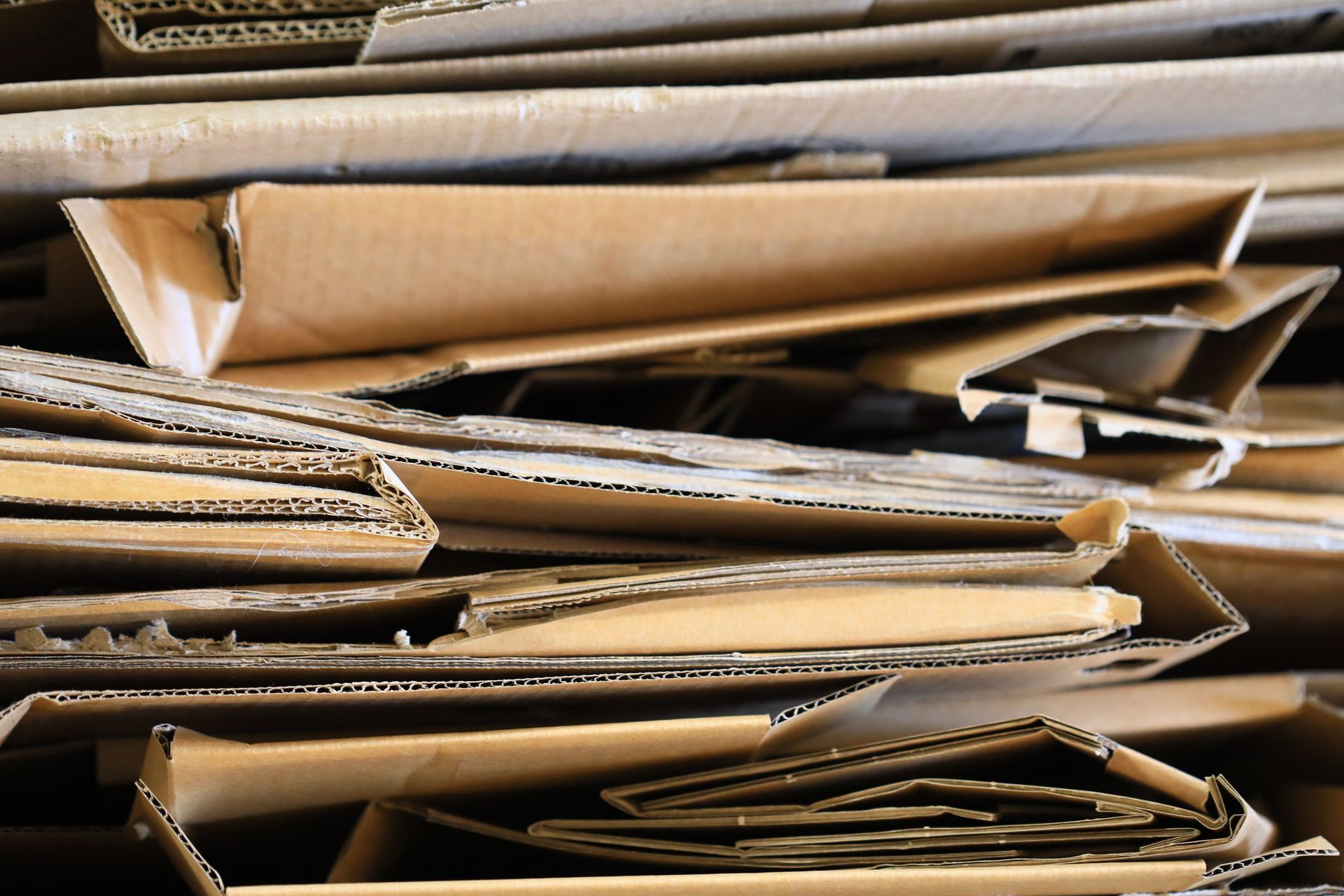 A pile of crashed cardboard boxes stacked on top of each other
