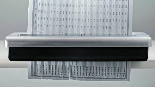 A piece of paper is being shredded by a machine