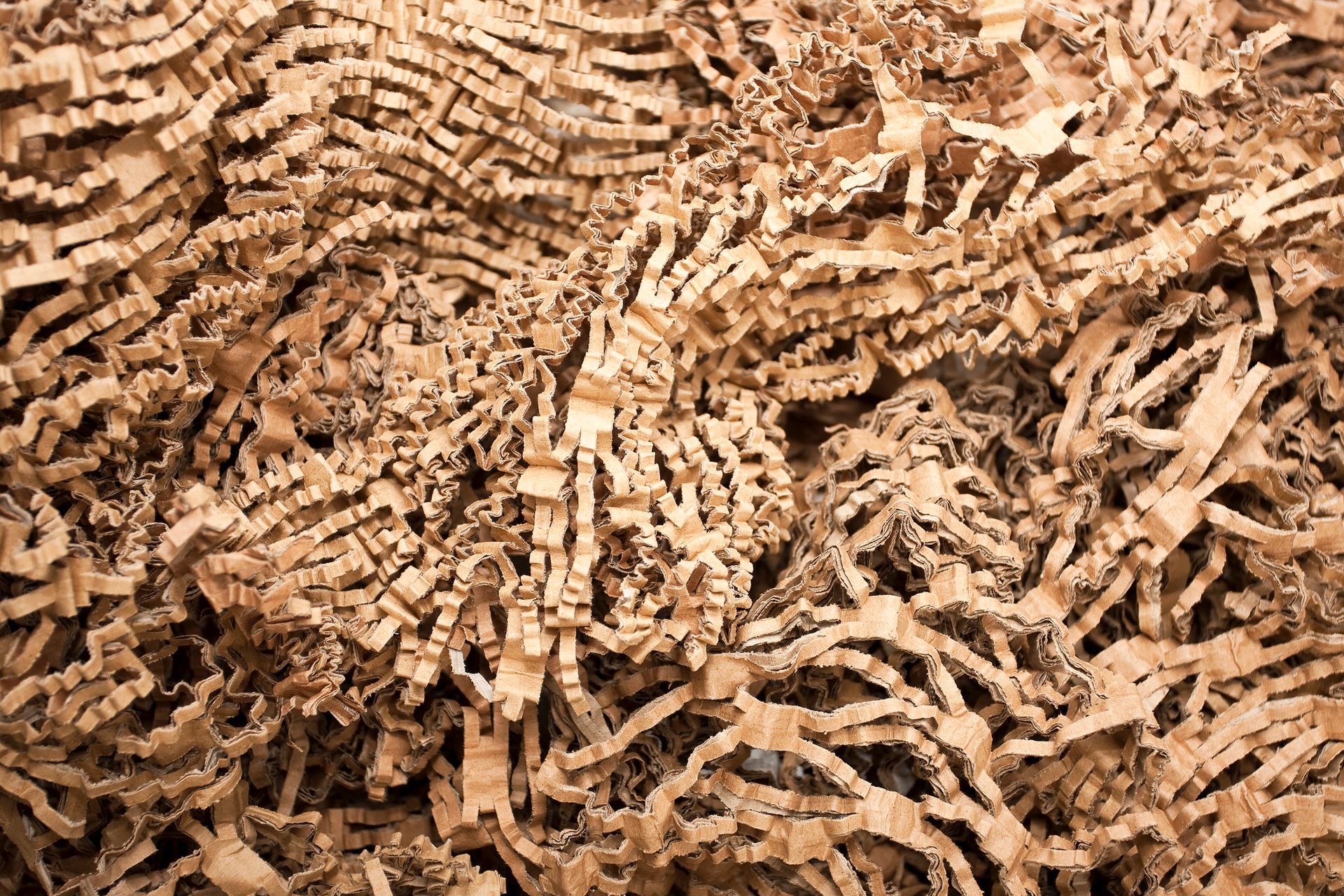 A pile of shredded cardboard is sitting on a table.