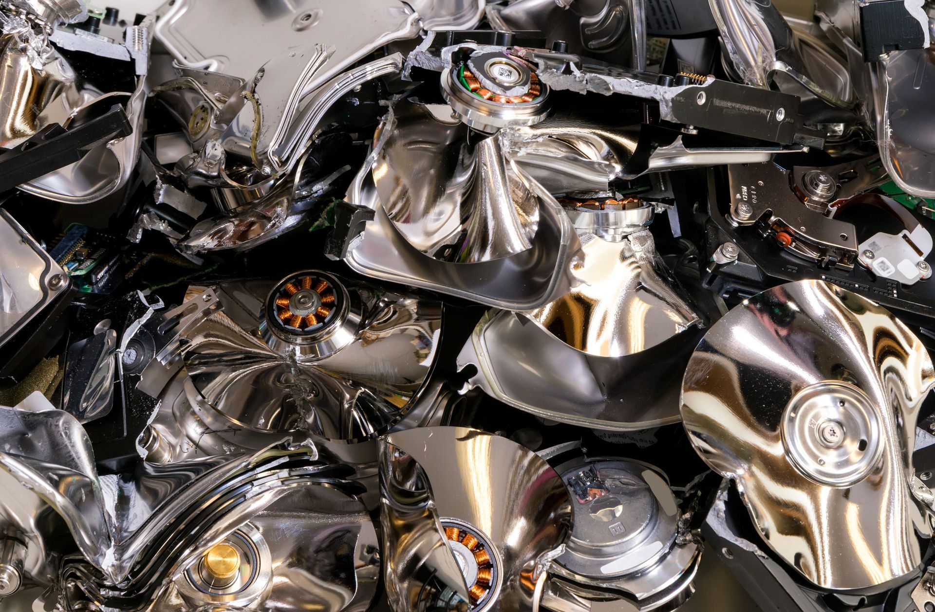 A pile of broken hard drives sitting on top of each other