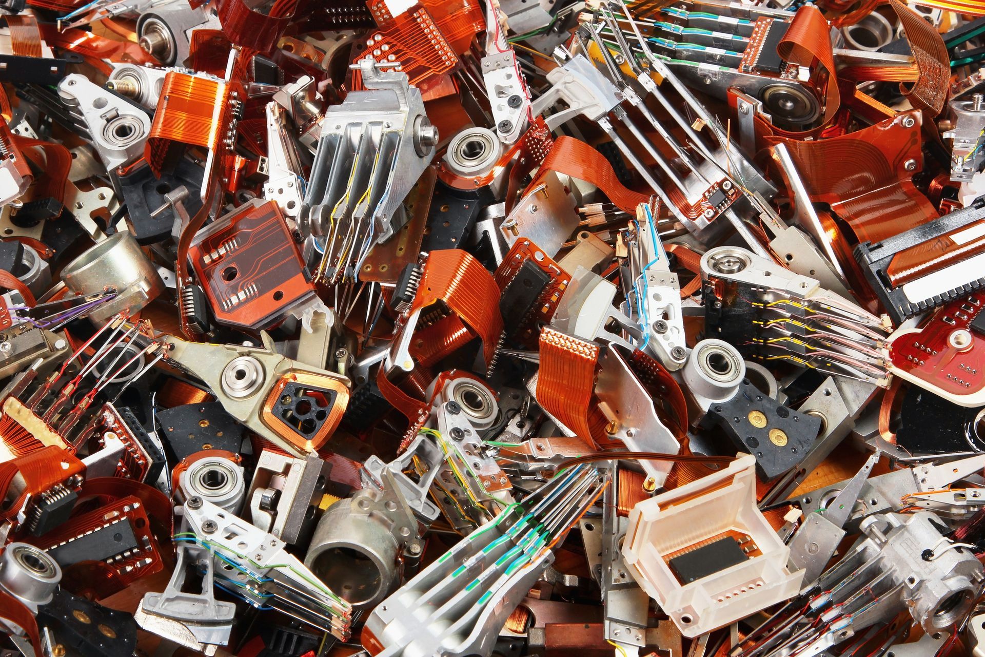 A pile of electronic parts including a bunch of keys
