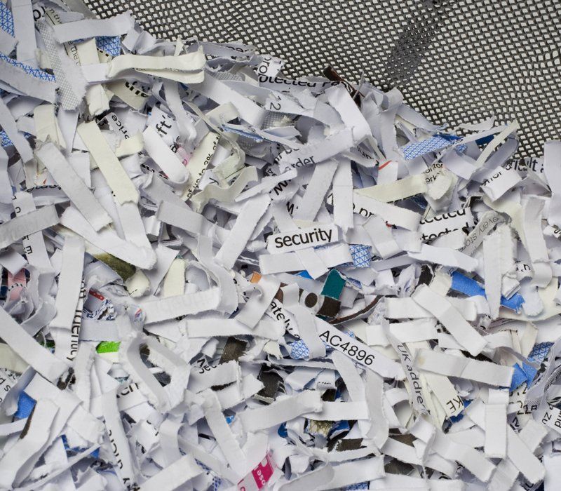 A pile of shredded paper with the word security on it