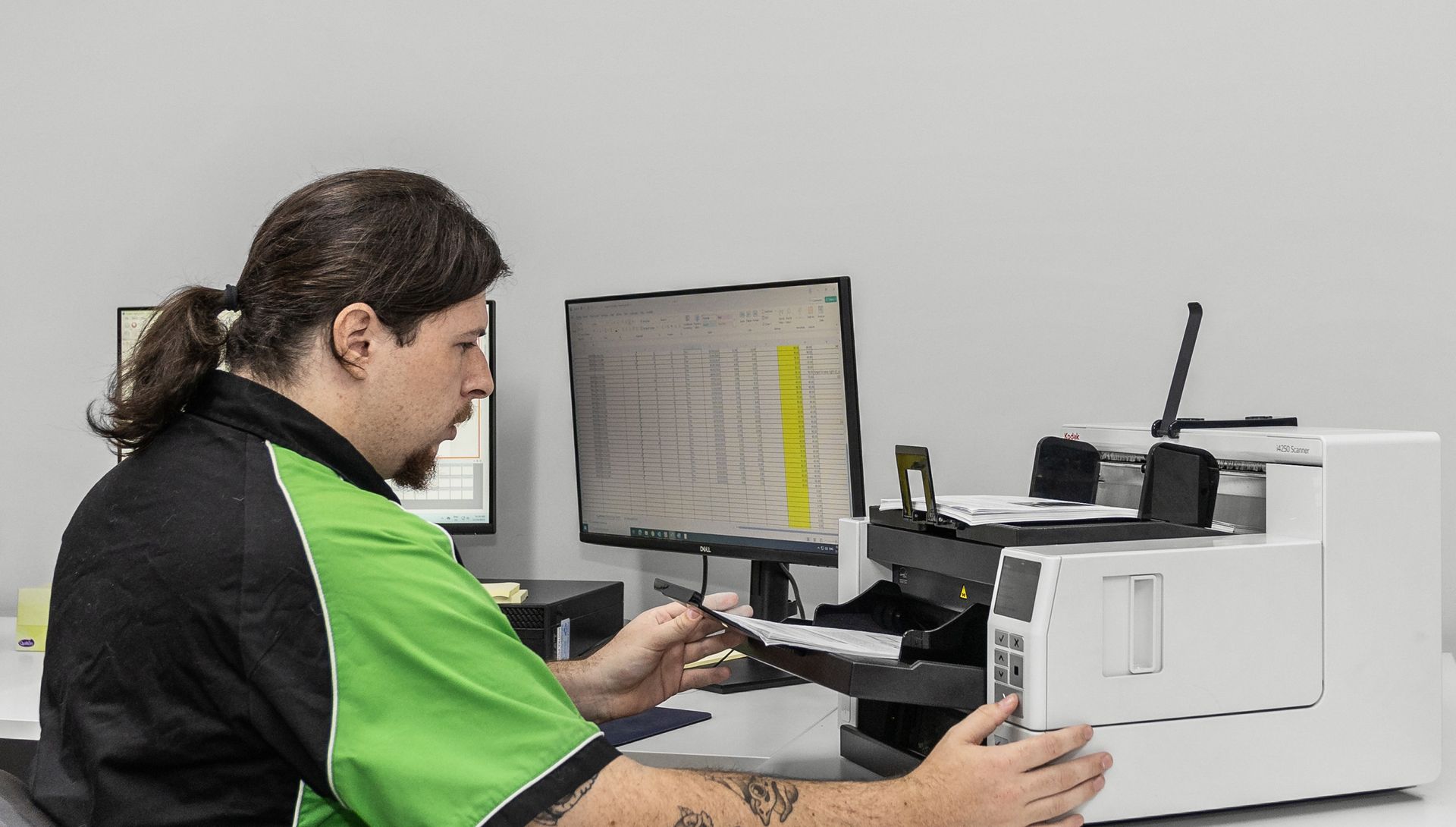 A woman is using a scanner to scan a document.