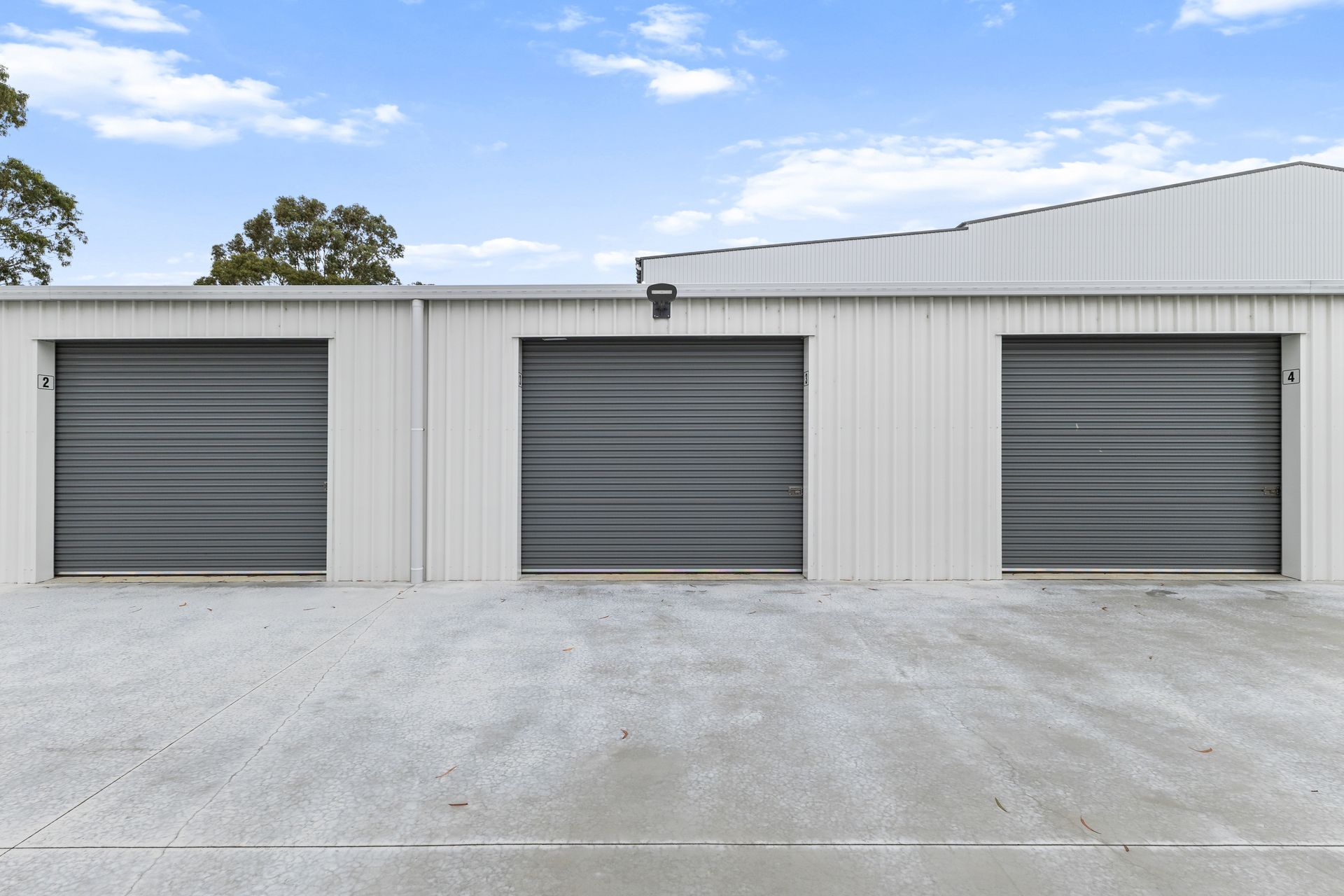 A hallway with green shutters and a padlock on the door.
