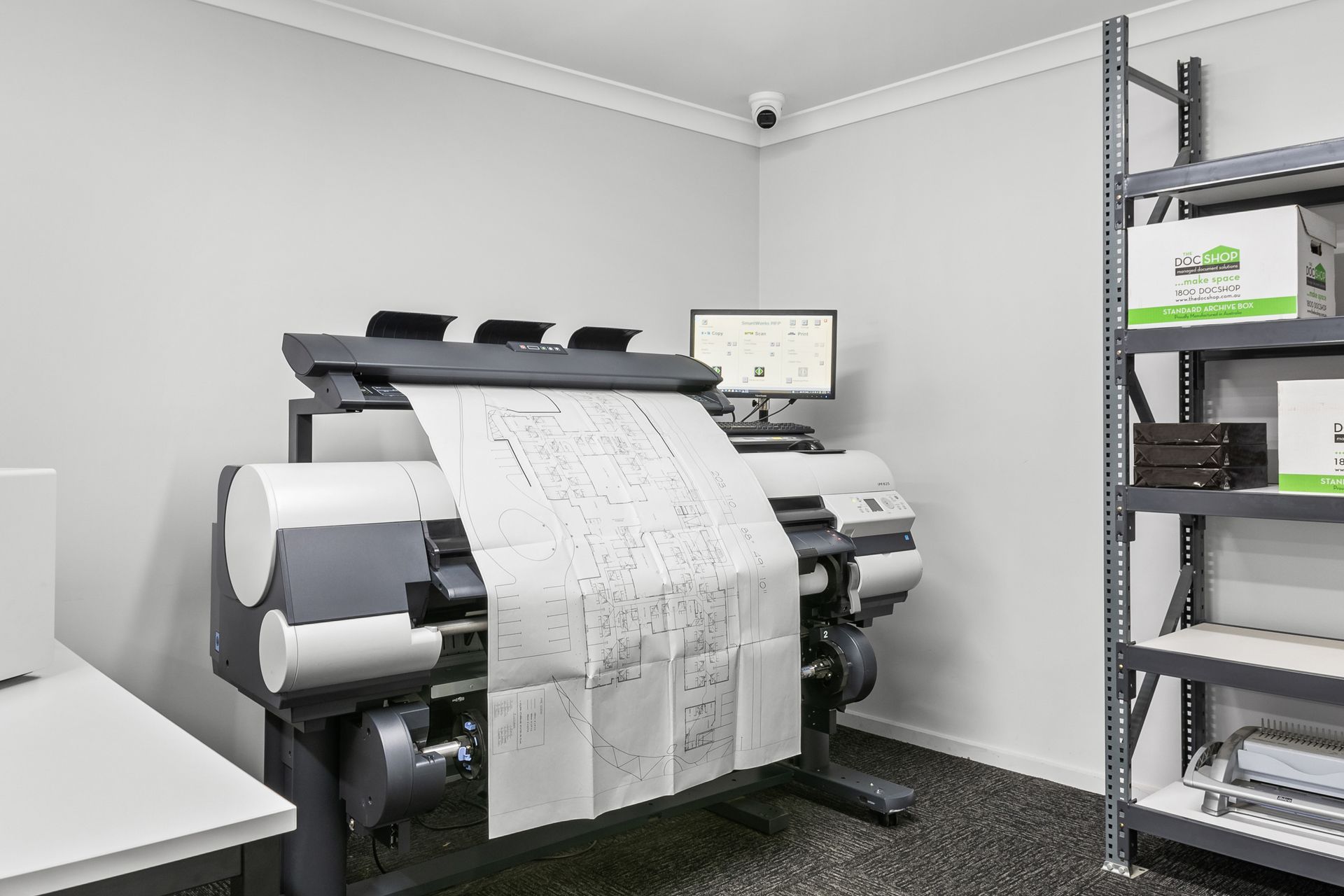 A person is using a printer to scan a piece of paper