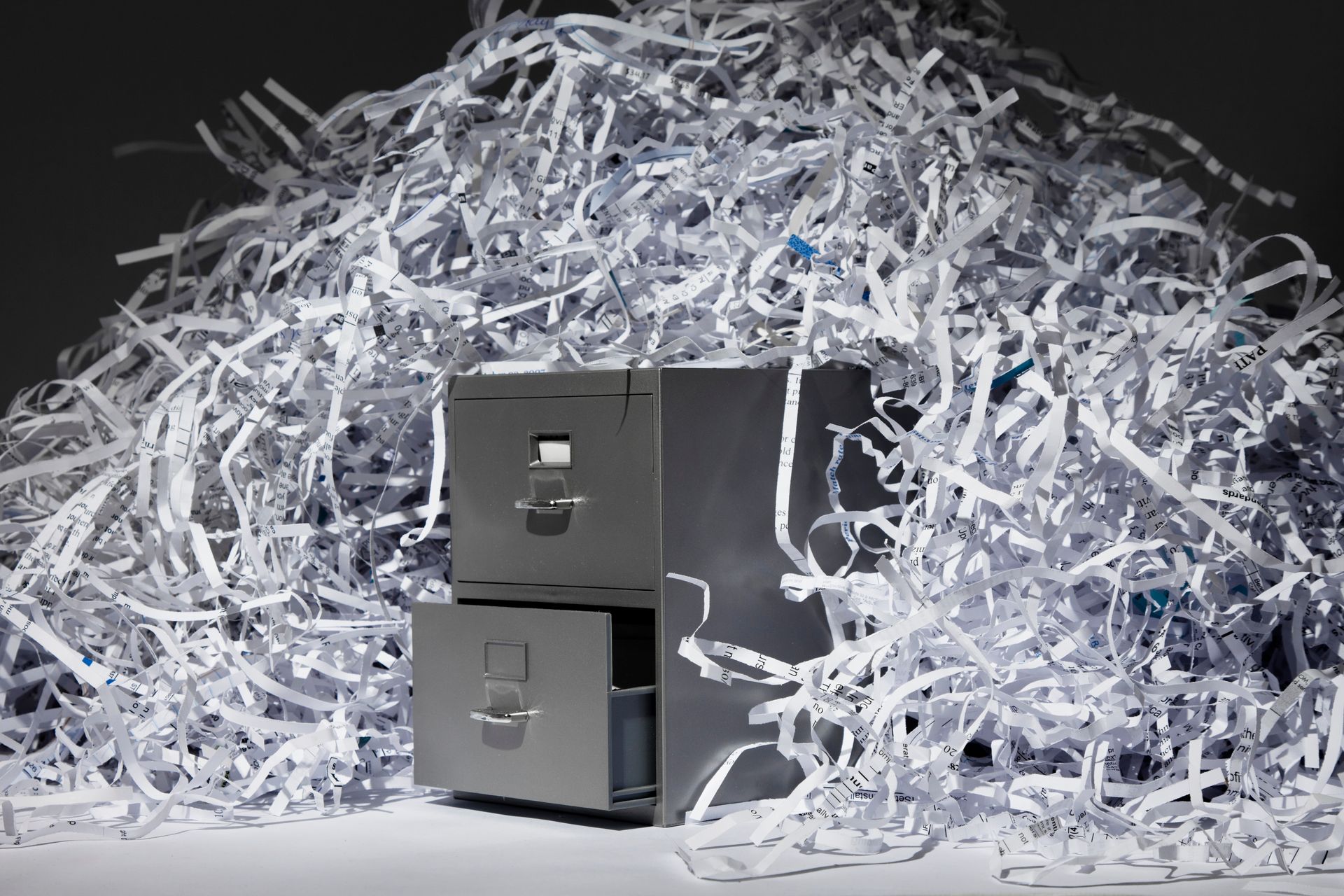 A file cabinet and lots of shredded paper.