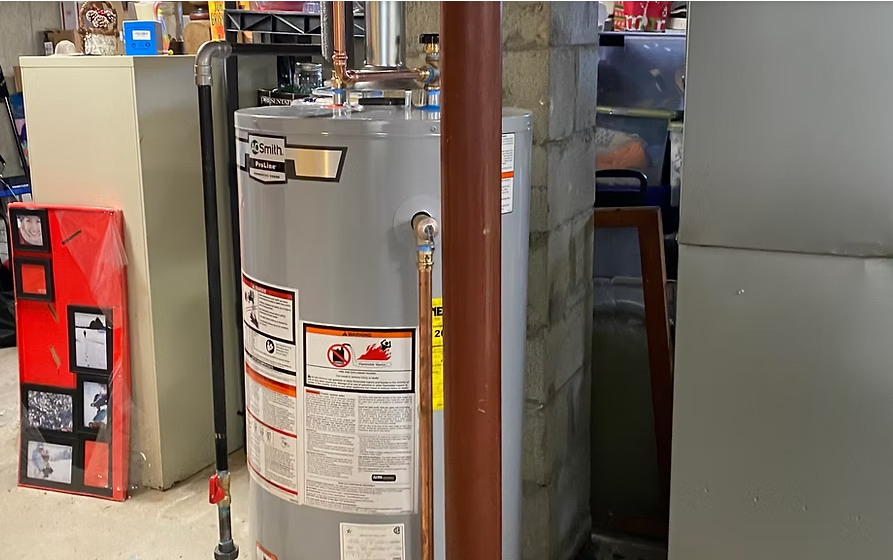 Water heater in a basement next to concrete wall and storage.