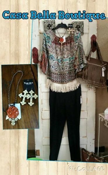 Boho blouse and black pants on mannequin with turquoise jewelry in boutique display