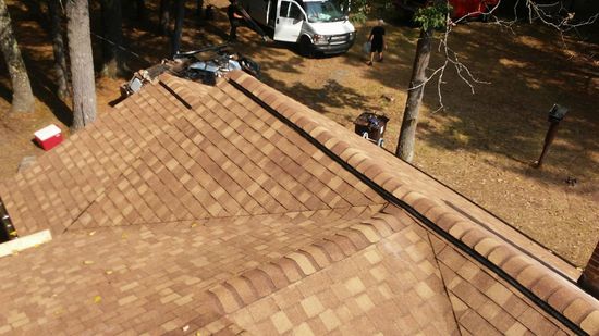 An aerial view of a roof with a truck parked in the background.