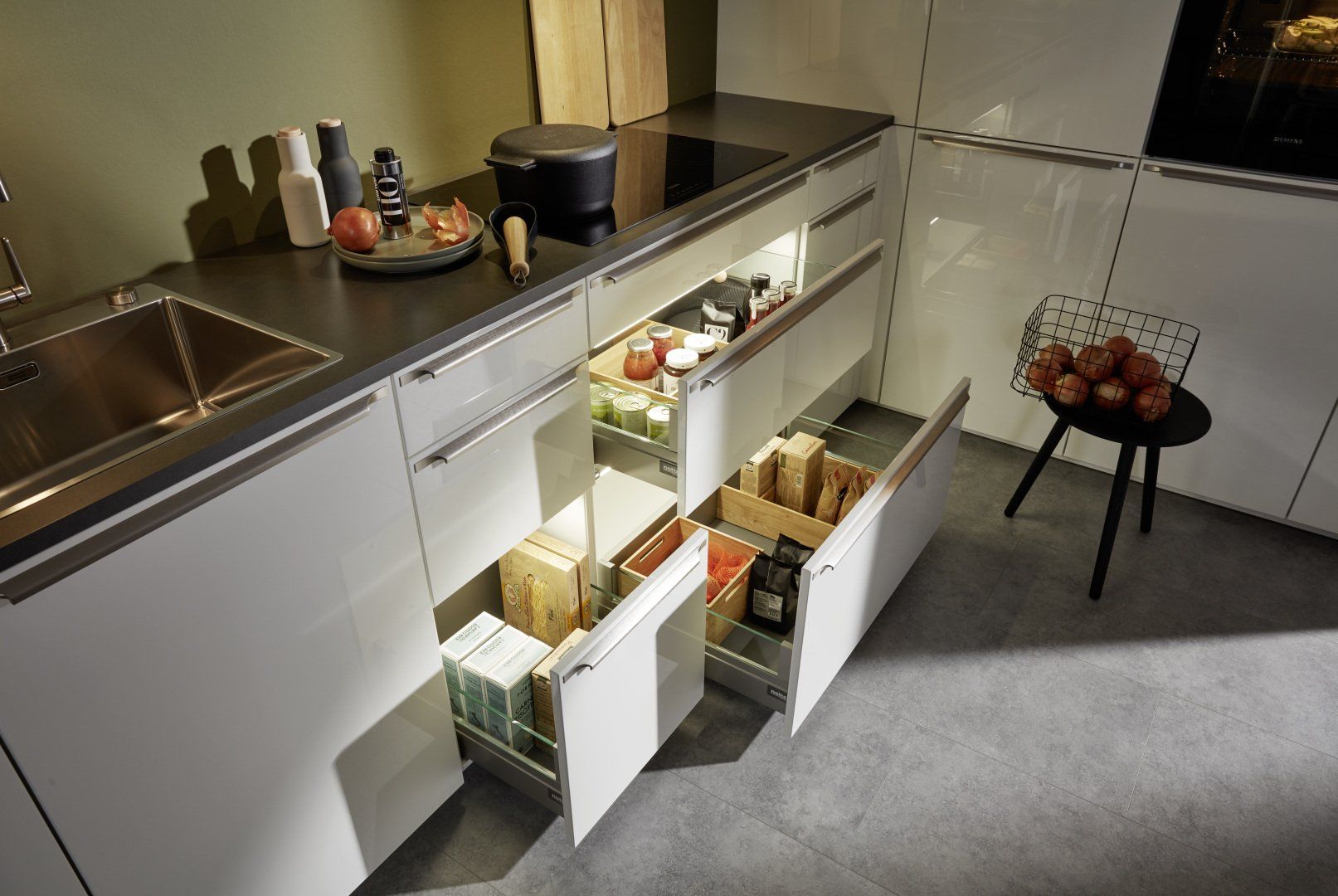 Une cuisine avec beaucoup de tiroirs ouverts et un évier