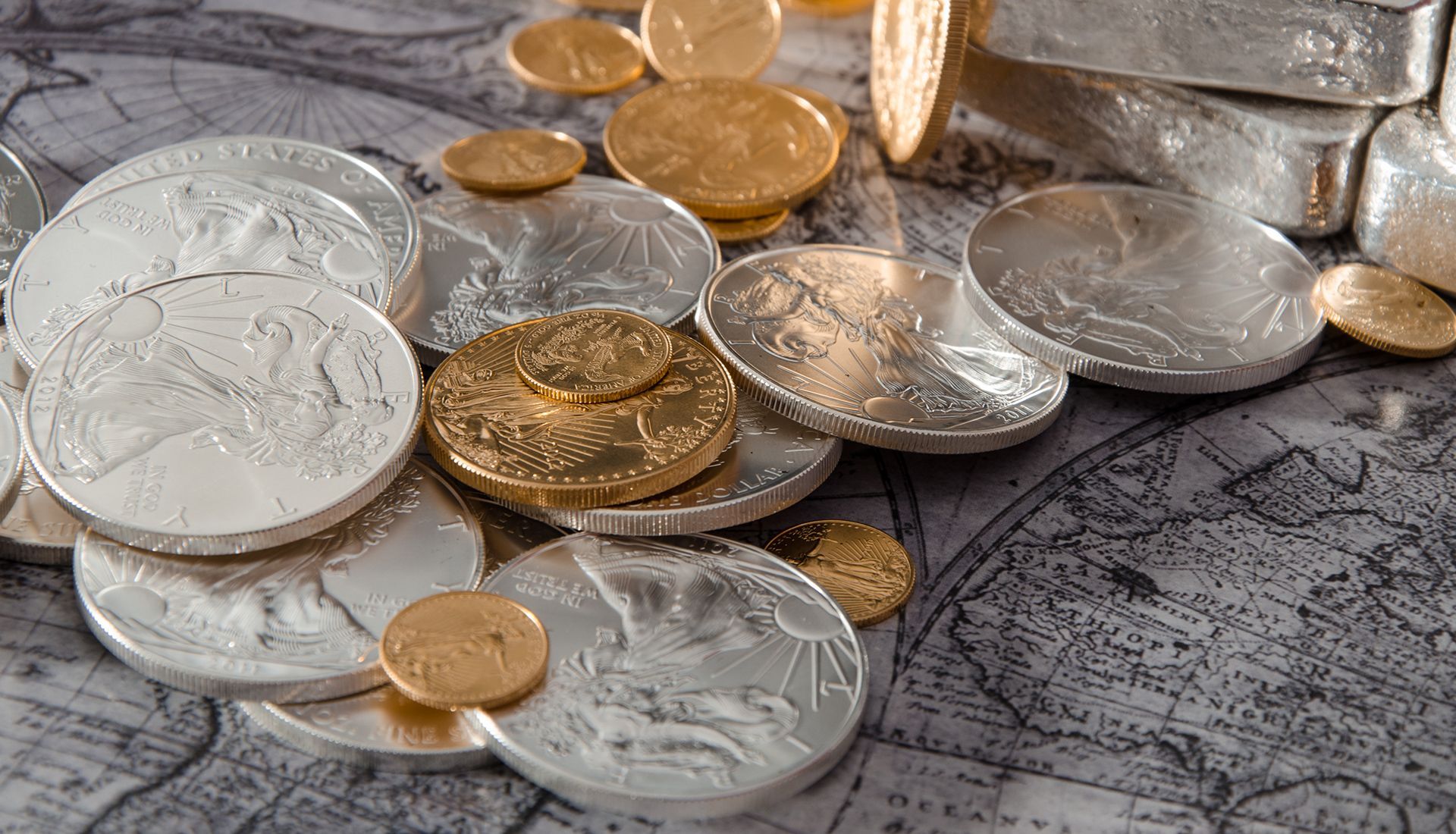 Silver and gold coins and bars on a map.