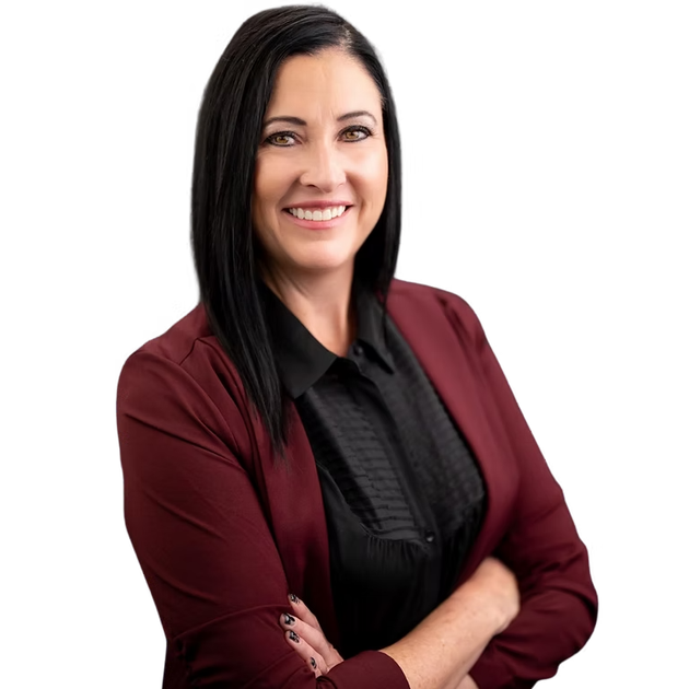 A woman in a maroon jacket and black shirt smiles with her arms crossed