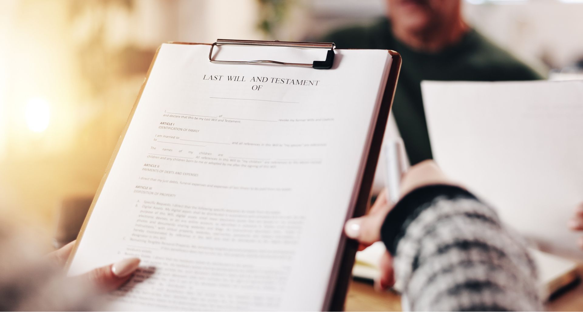 A person is holding a clipboard with a piece of paper on it.