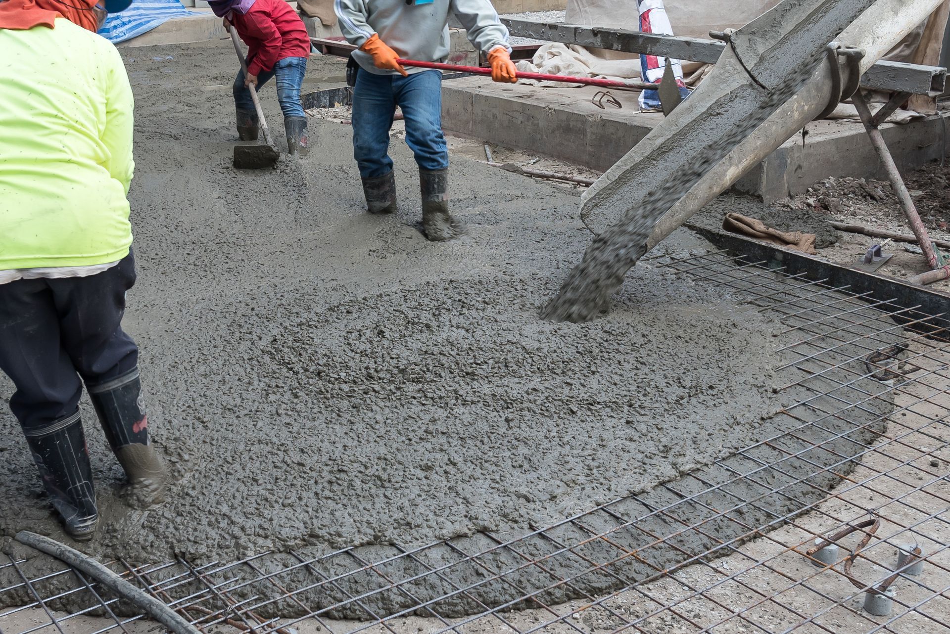 Workers at the construction site placing concrete slab. Workers at the construction site placing concrete slab.