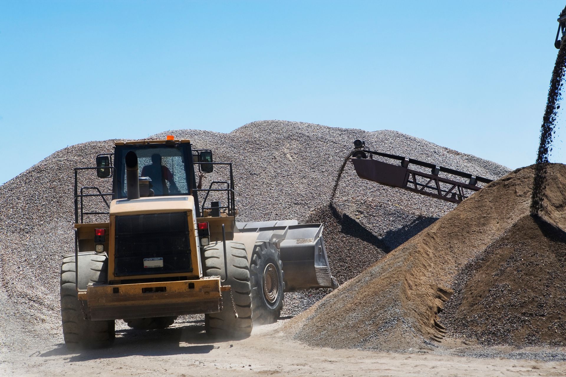 A bulldozer moves sand to assist construction efforts for a concrete ready mix supplier.
