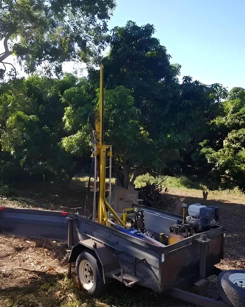 A Trailer With A Machine On It Is Parked In A Field — PGI North QLD In Rosslea, QLD