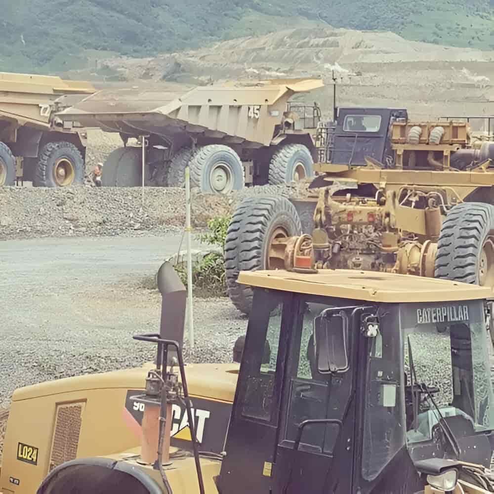 A Cat Tractor Is Parked Next To A Dump Truck — PGI North QLD In Rosslea, QLD