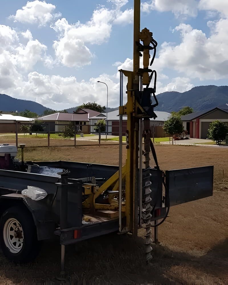 A Trailer With A Yellow Drill Attached To It — PGI North QLD In Rosslea, QLD