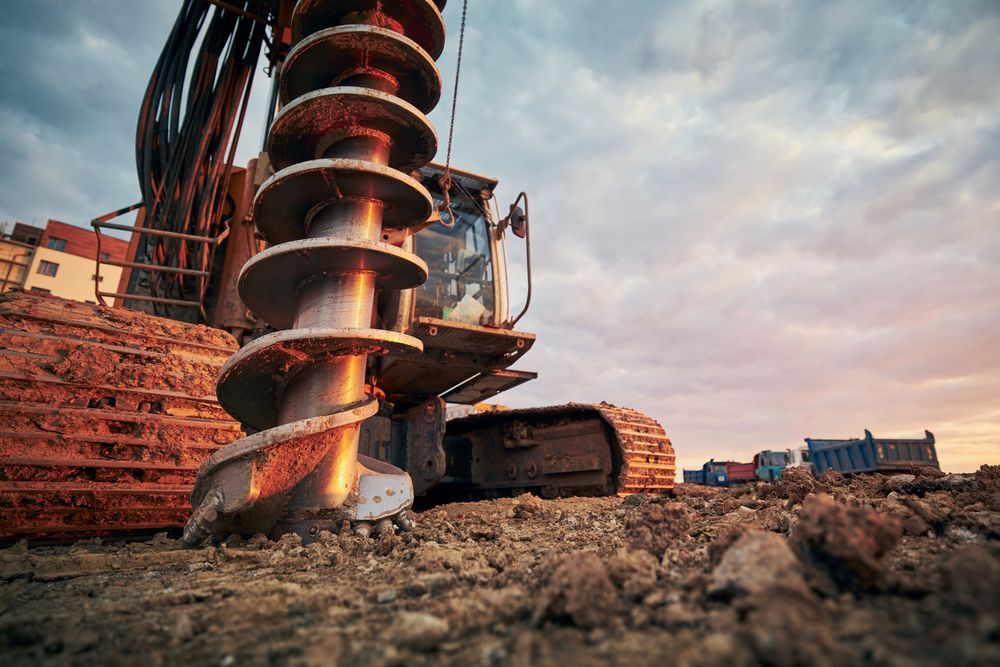 A Bulldozer Is Drilling A Hole In The Ground At A Construction Site — PGI North QLD In Charters Towers, QLD