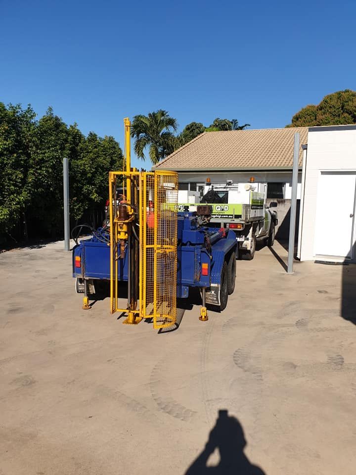 A Blue Trailer With A Yellow Drill On It Is Parked — PGI North QLD In Charters Towers, QLD