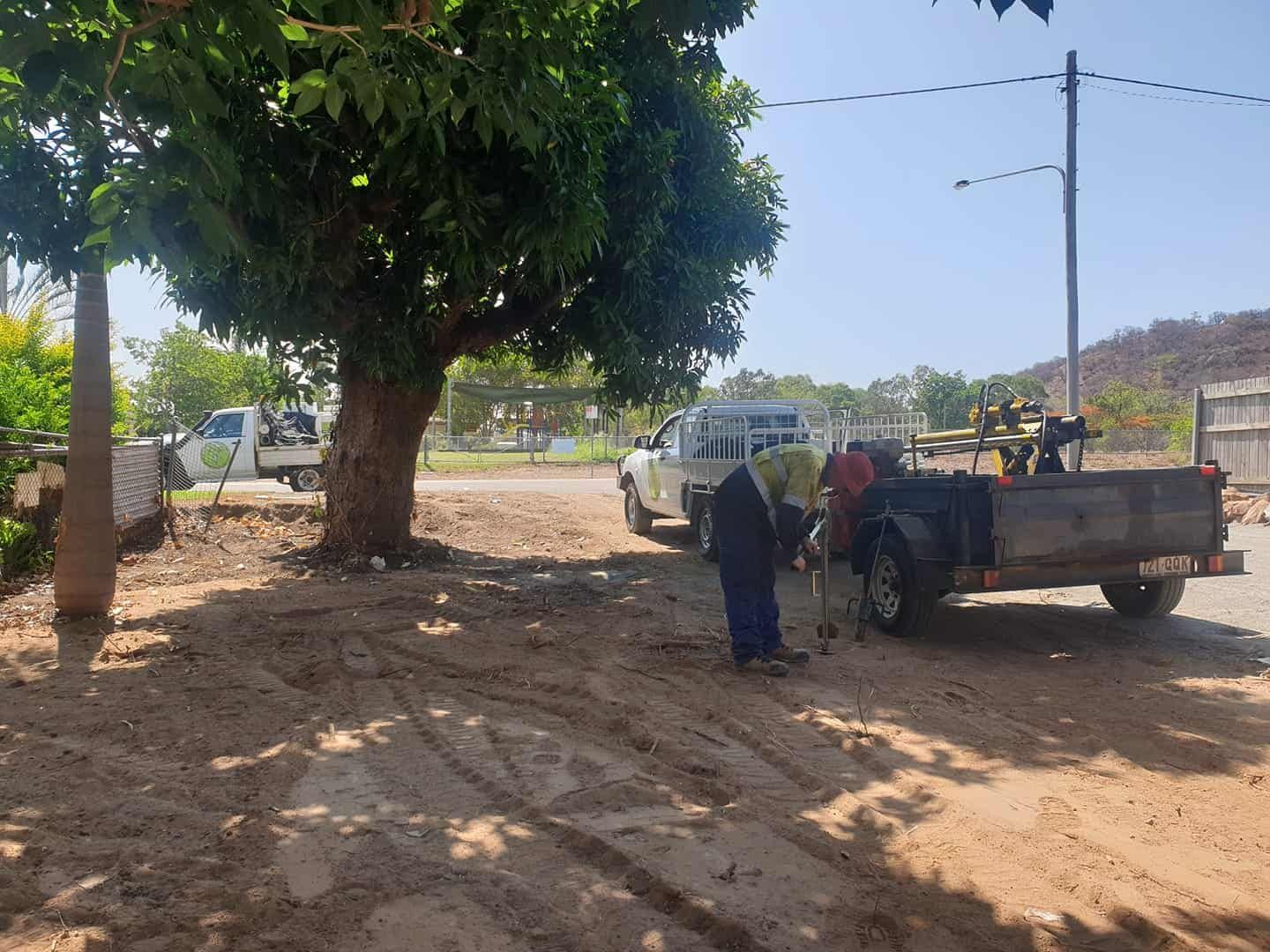 A Man Is Standing Next To A Truck With A Trailer — PGI North QLD In Bowen, QLD