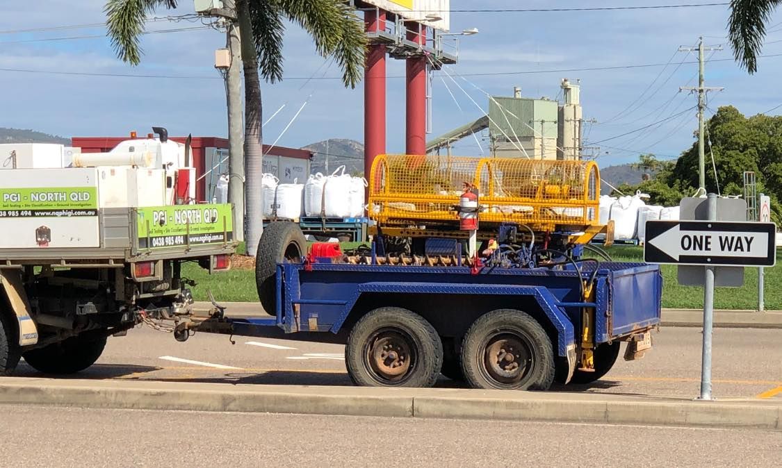 A Truck With A Trailer Attached To It Is Parked On The Side — PGI North QLD In Bowen, QLD