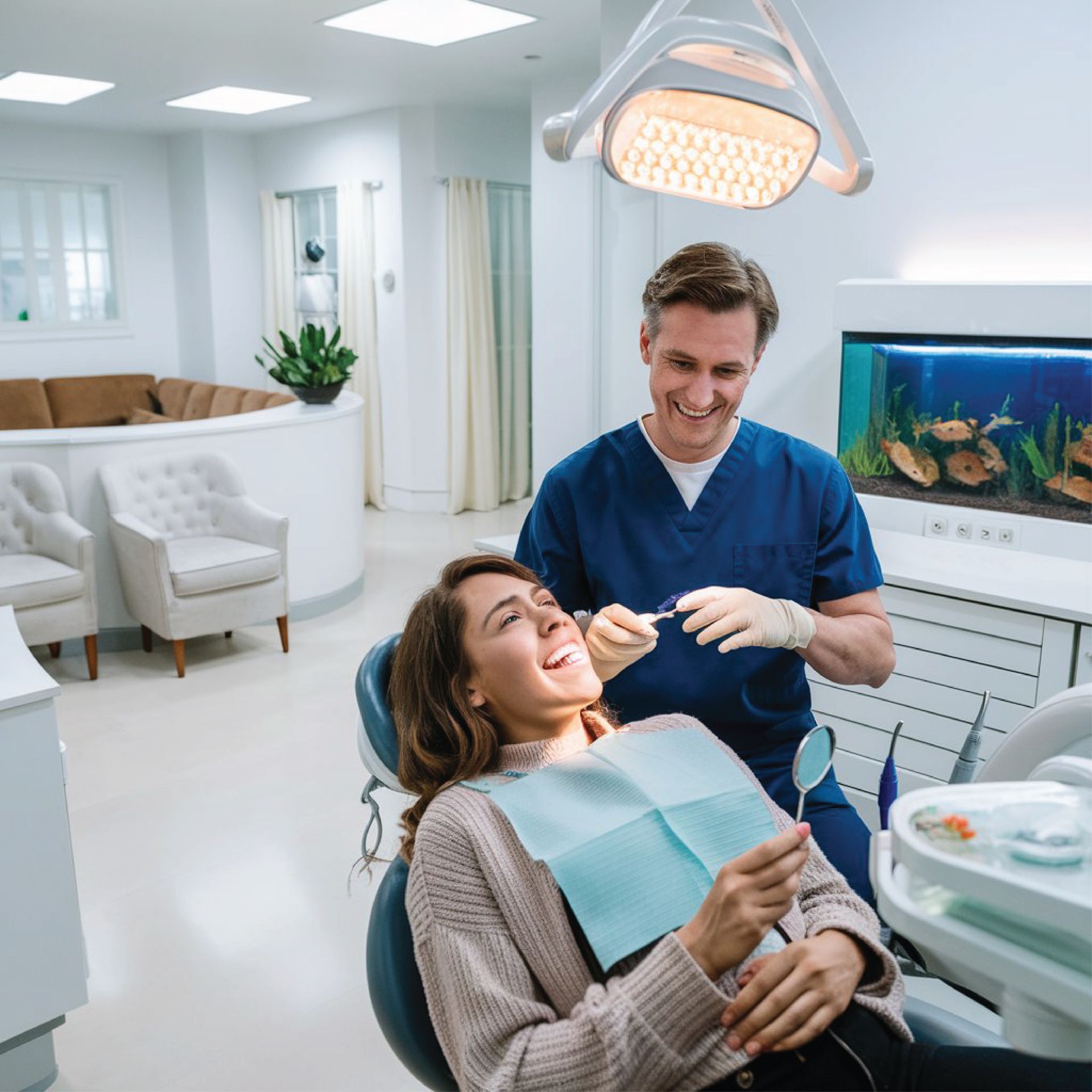 A woman is sitting in a dental chair while a dentist examines her teeth.