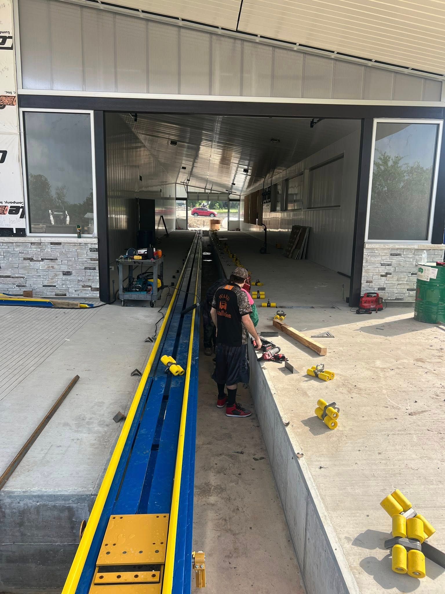 Building a carwash. Rendering of building. Express car wash installation in San Antonio Texas for Kwik-n-Clean Car Wash with road runner logo