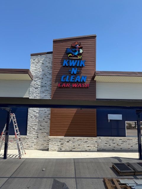 Building a carwash and installing a sign. Express car wash installation in San Antonio Texas for Kwik-n-Clean Car Wash with road runner logo