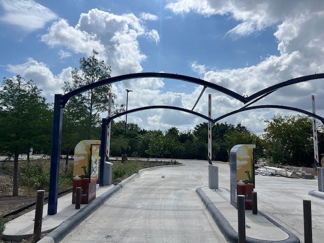 Building a carwash. pay station entry. Express car wash installation in San Antonio Texas for Kwik-n-Clean Car Wash with road runner logo