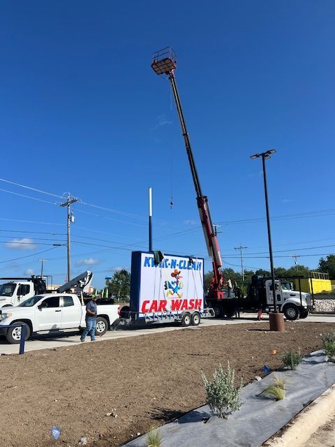 Building a carwash and installing a sign. Express car wash installation in San Antonio Texas for Kwik-n-Clean Car Wash with road runner logo