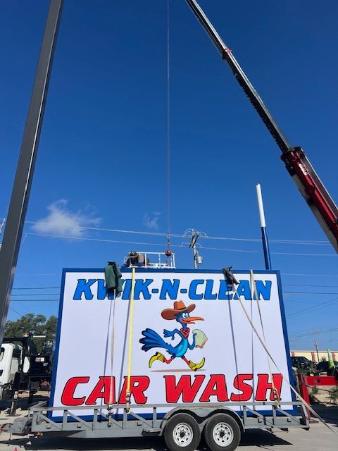 Building a carwash and installing a sign. Express car wash installation in San Antonio Texas for Kwik-n-Clean Car Wash with road runner logo