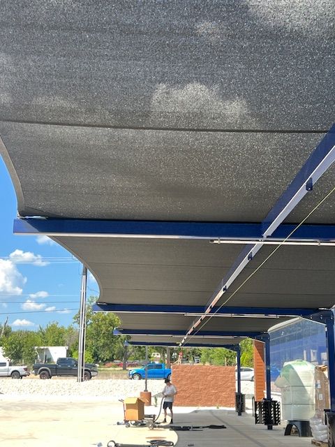 Building a carwash. Rendering of building. Express car wash installation in San Antonio Texas for Kwik-n-Clean Car Wash with road runner logo