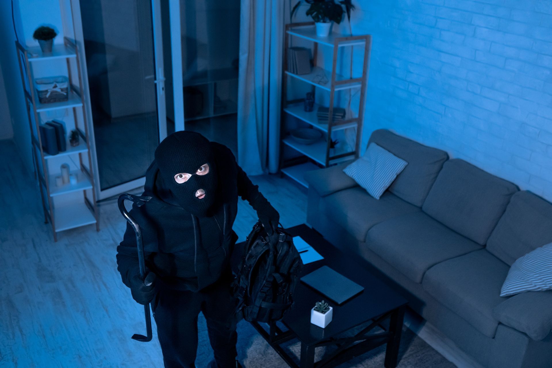 The surveillance camera captured as a masked thief breaks the house.