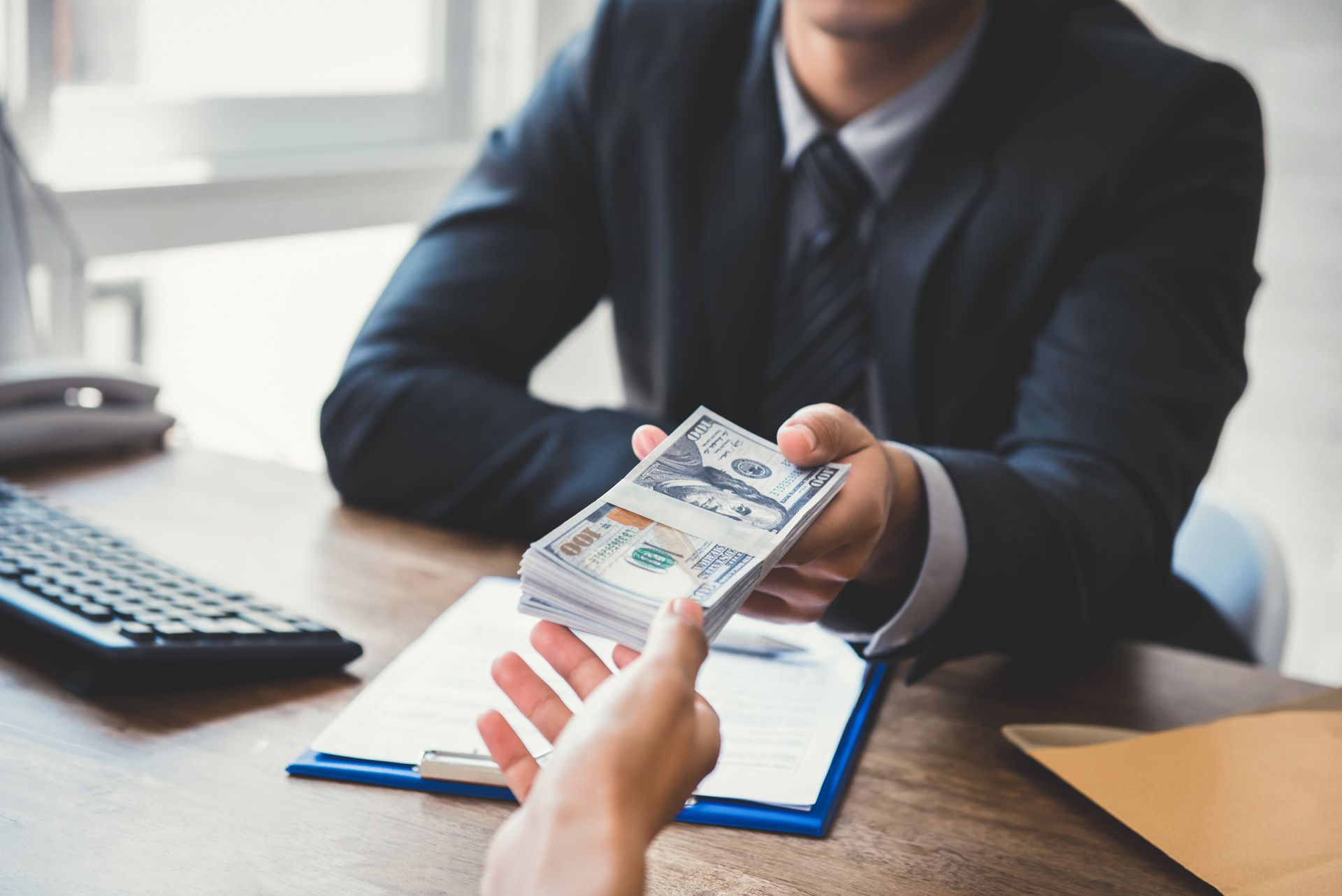 Giving money to his partner while making contract.