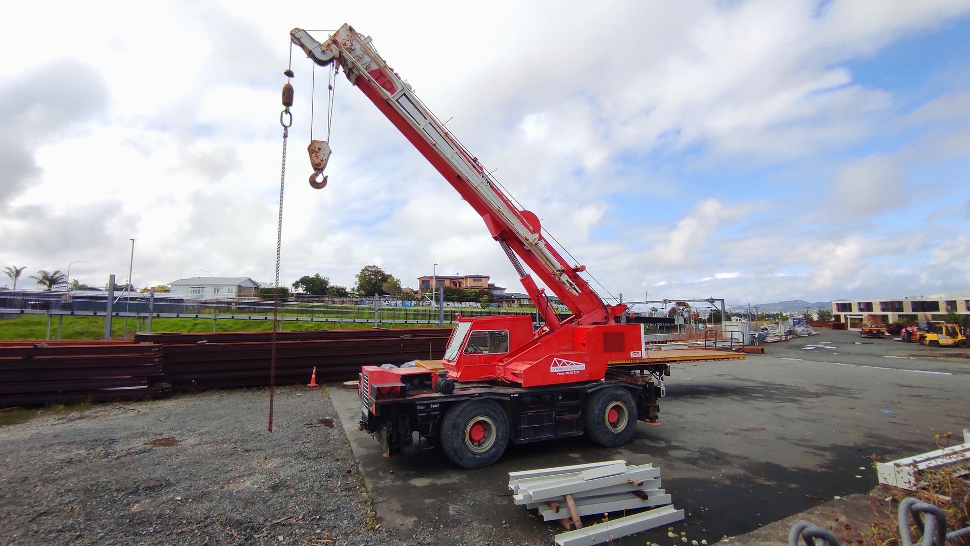 ed Franna crane on construction site with boom extended, available for reliable Franna crane hire. ed Franna crane on construction site with boom extended, available for reliable Franna crane hire.