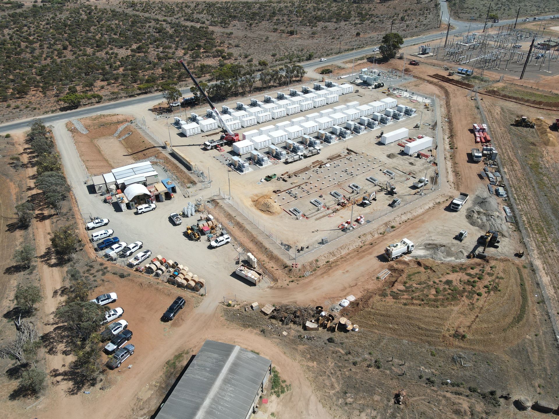 Aerial view of an AGL & Son crane operating at a large construction site