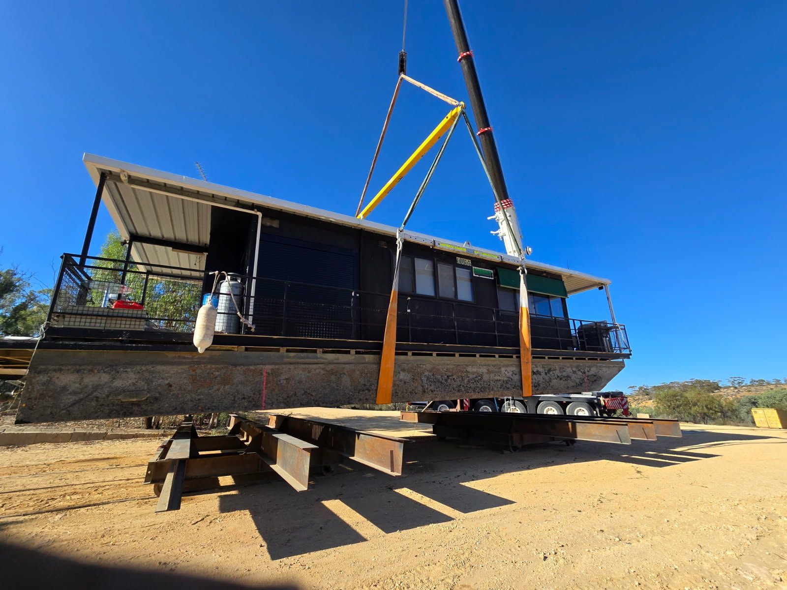 AGL & Son | 160T crane lifting a houseboat