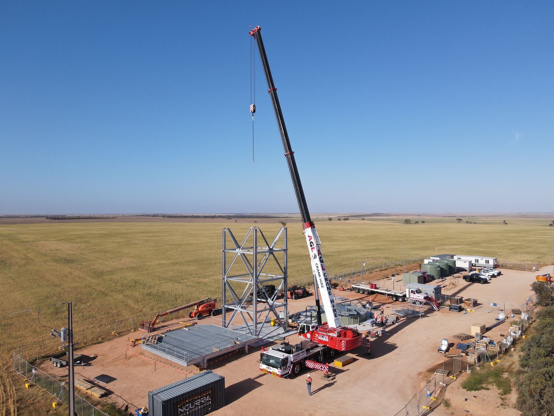 AGL & Son Crane Hire’s crane lifting materials at a construction project site