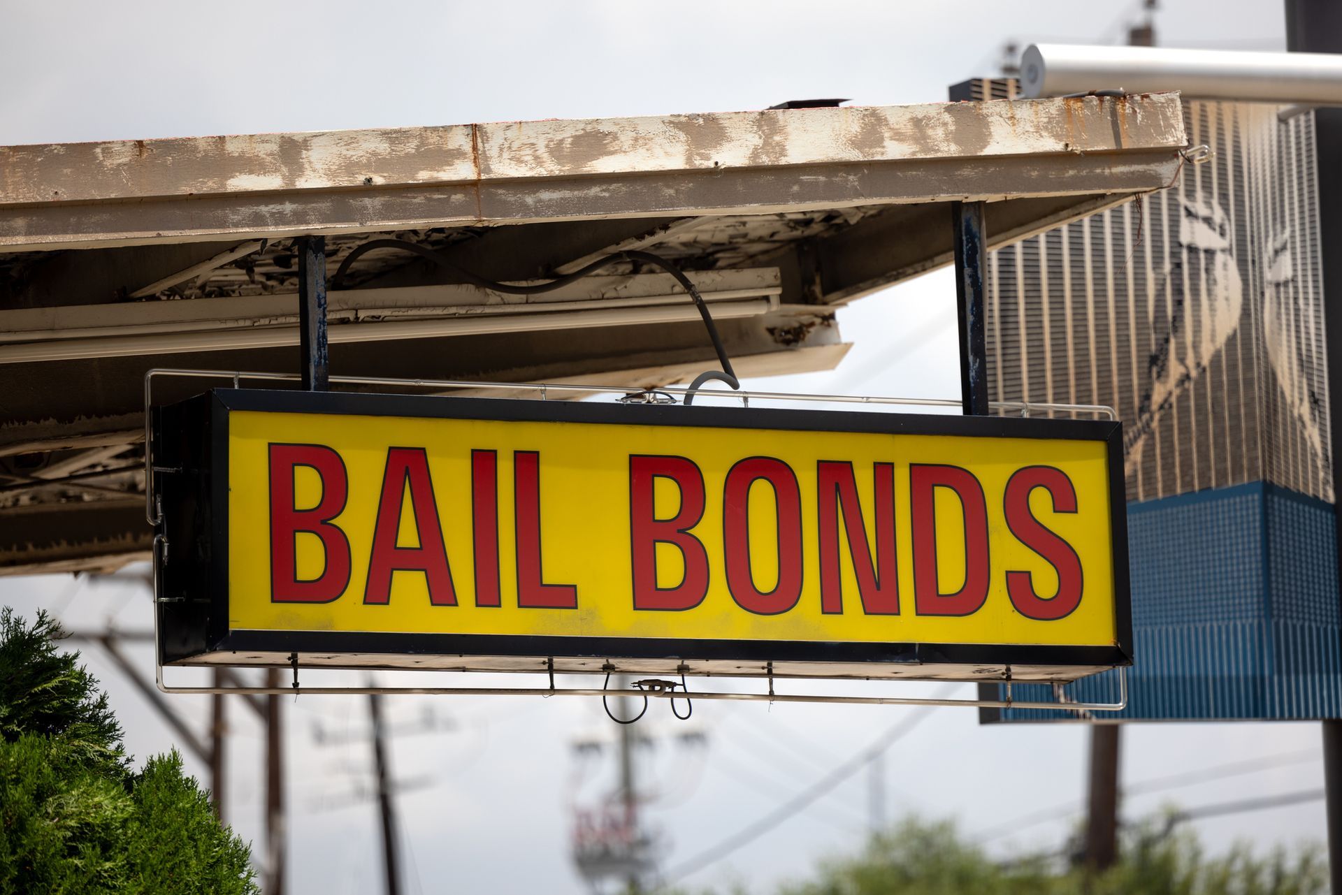 Photo of a rundown bail bonds sign near a downtown courthouse.