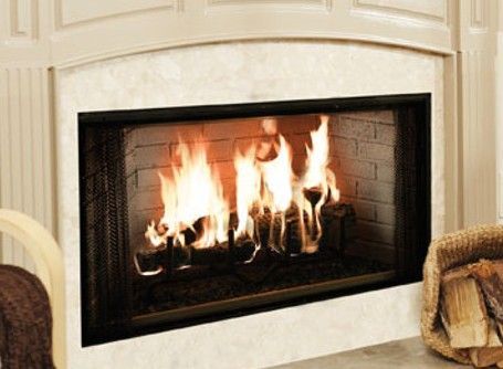 A fireplace with a basket of logs in front of it