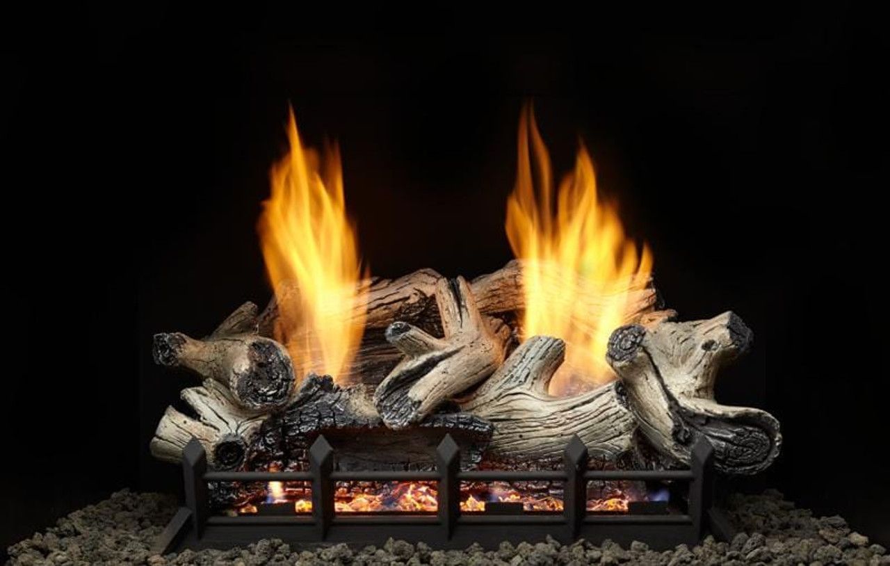 A fireplace with logs and flames coming out of it.