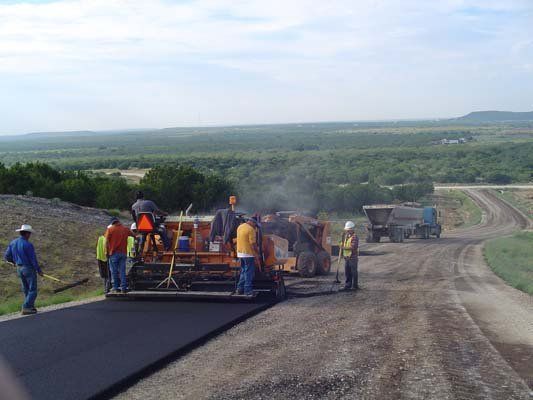A group of people are working on a road.