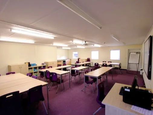 Classroom with chairs, tables, and ceiling lights