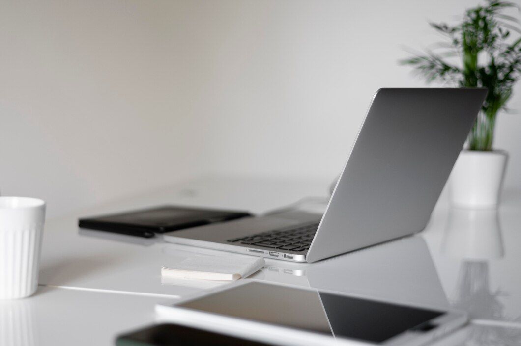 A laptop and a cup placed on a desk