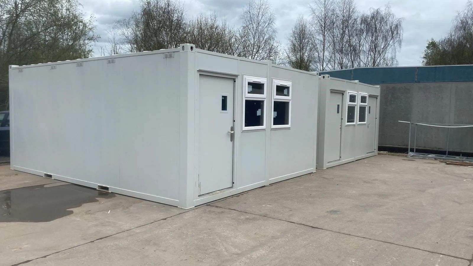 Two grey portable cabins