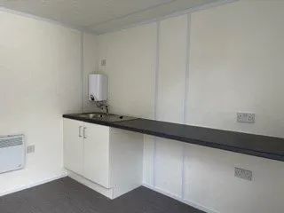 Kitchen side with a boiler on the left and a cupboard directly beneath it