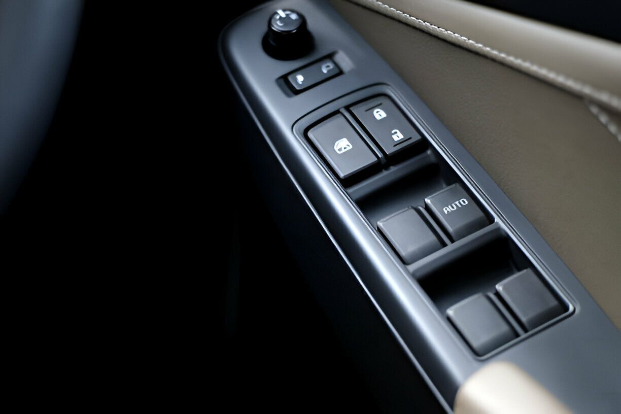 A close up of a car window control panel